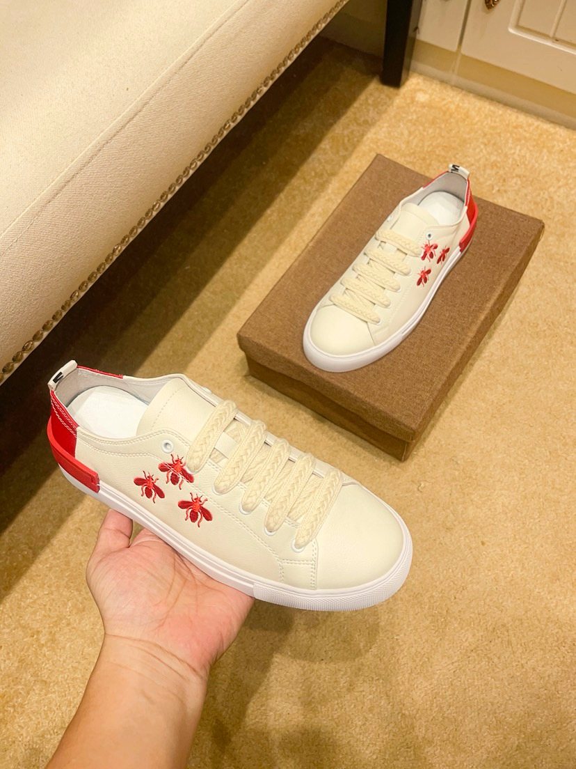 White Low-Top Sneakers with Red Floral Accents — model