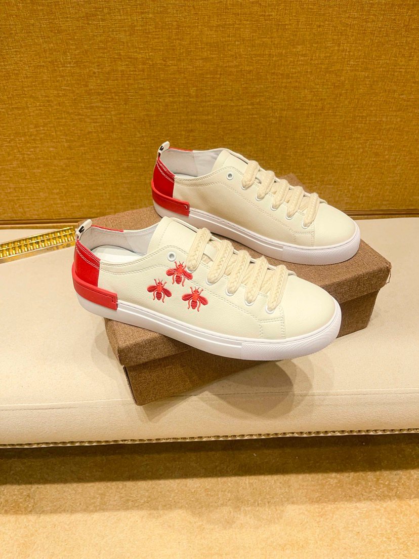 White Low-Top Sneakers with Red Floral Accents — hero