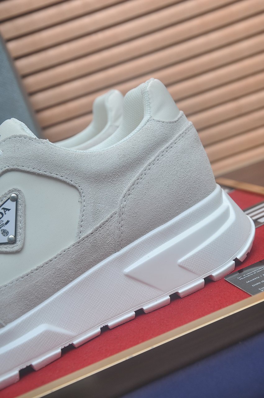 Prada Triangle Plaque Low-Top Sneakers — detail