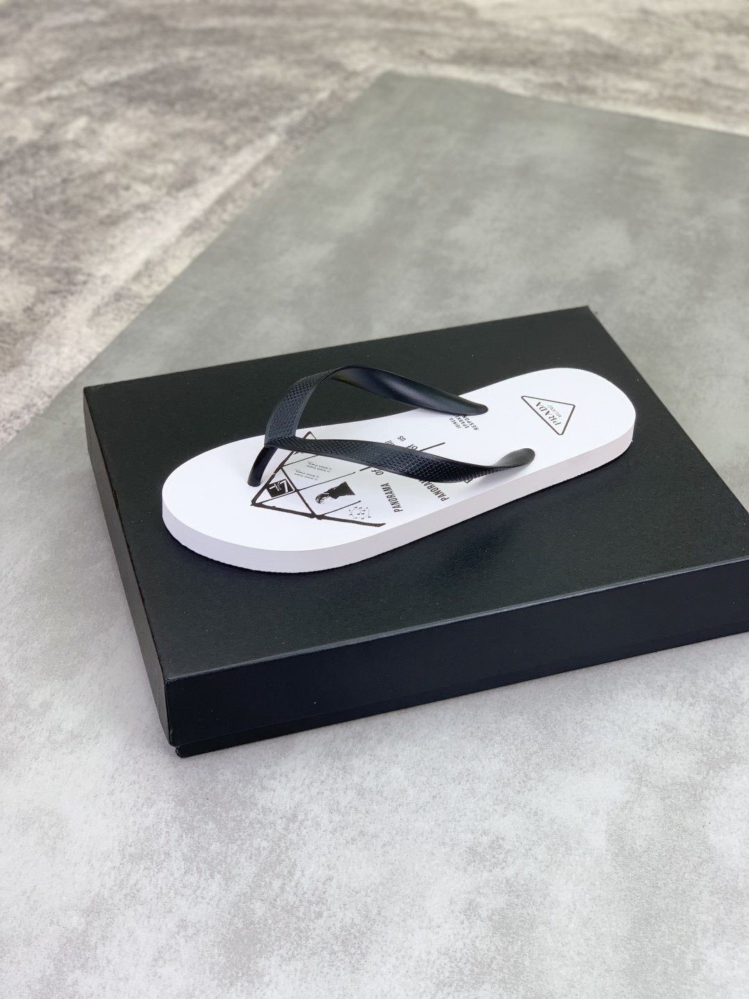 Prada Black Strap White Flip Flops — front