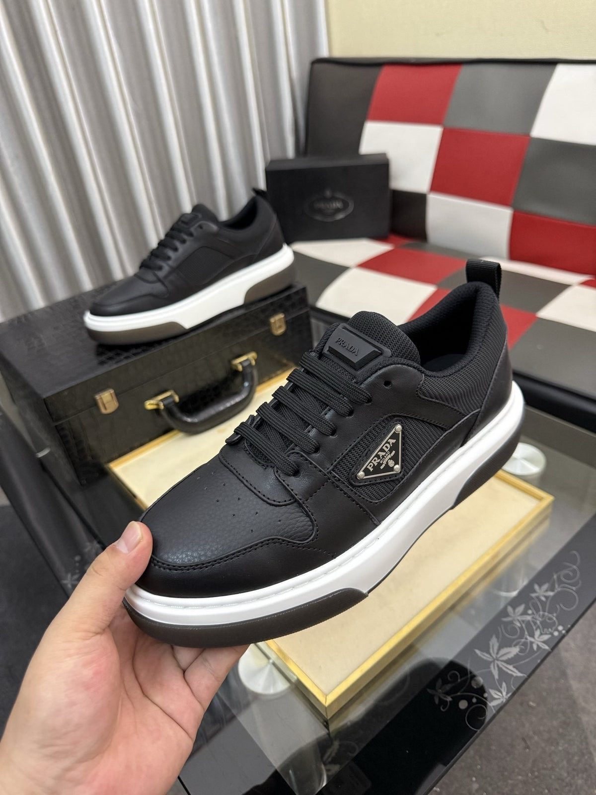 Prada Triangle Plaque Low-Top Sneakers — model