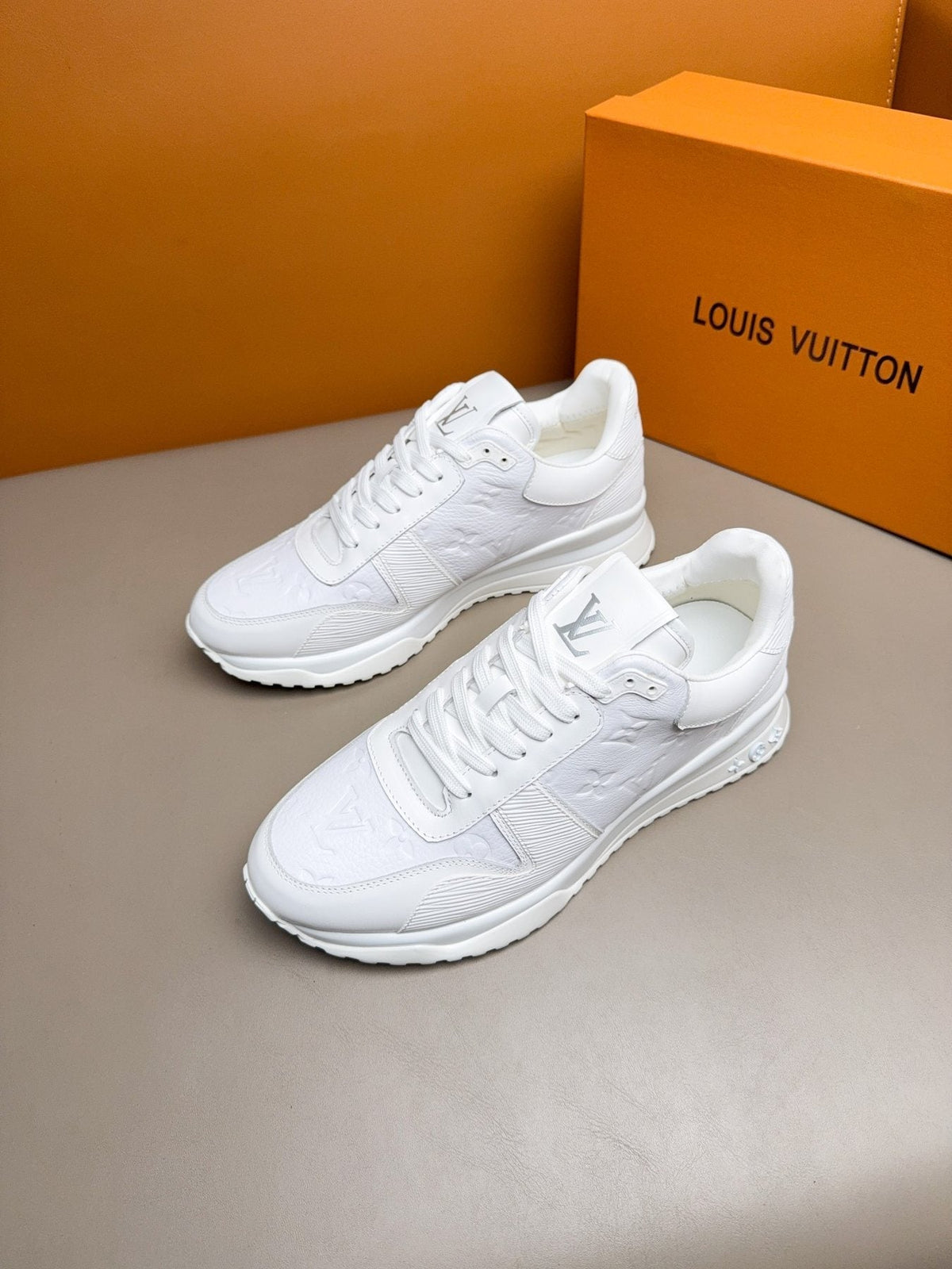 Louis Vuitton Embossed Low-Top Sneakers — front